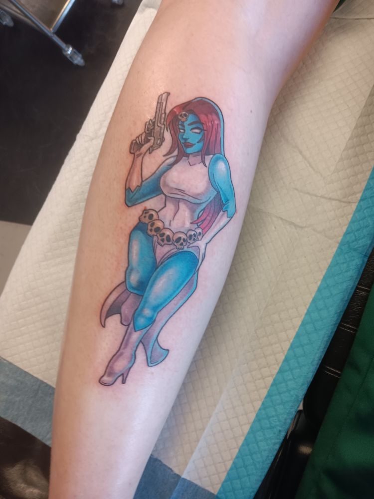 A pin-up tattoo on the back of my left calf. It depicts Mystique in her classic outfit, holding a pistol
