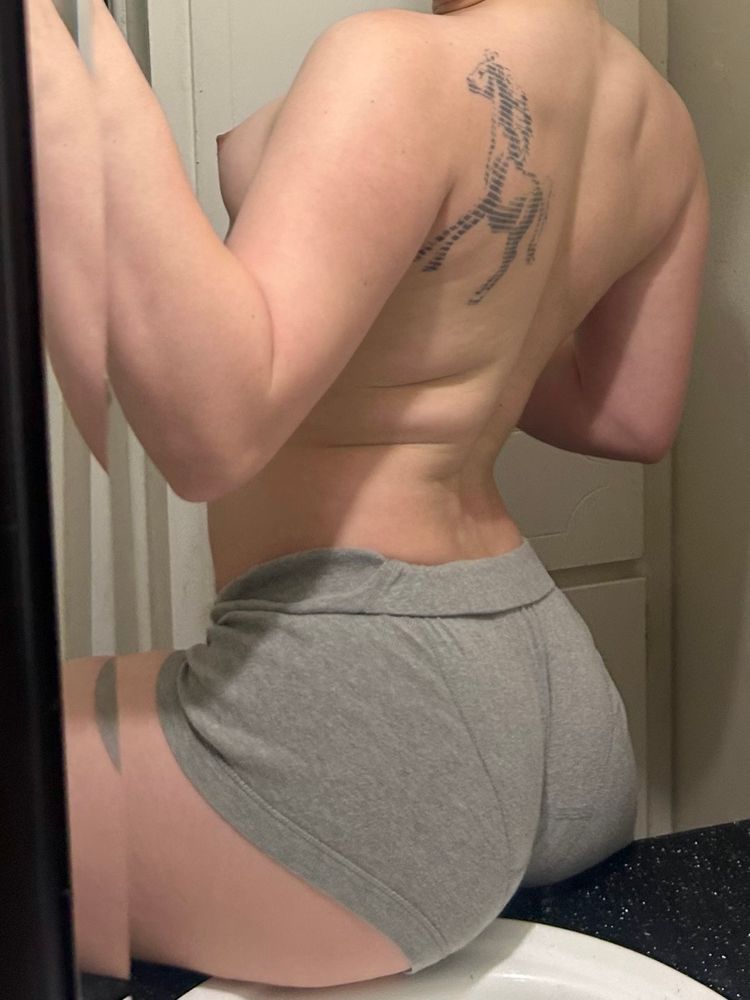 trans girl back shot, ass and breasts tits visible. tattoo