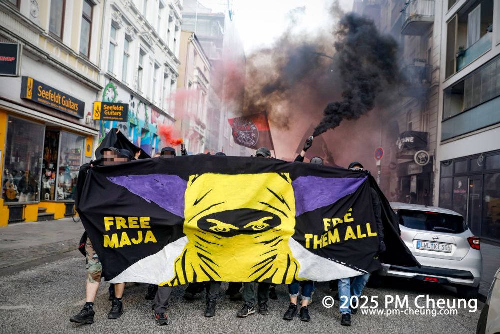 Die Demonstrant*innen bewegen sich durch die Talstraße in Richtung Schanzenviertel. Auf einem Transparent ist die Botschaft "Free Maja" und "Free them all!" zu lesen. Einige der Demonstrant*innen haben Pyrotechnik angezündet.