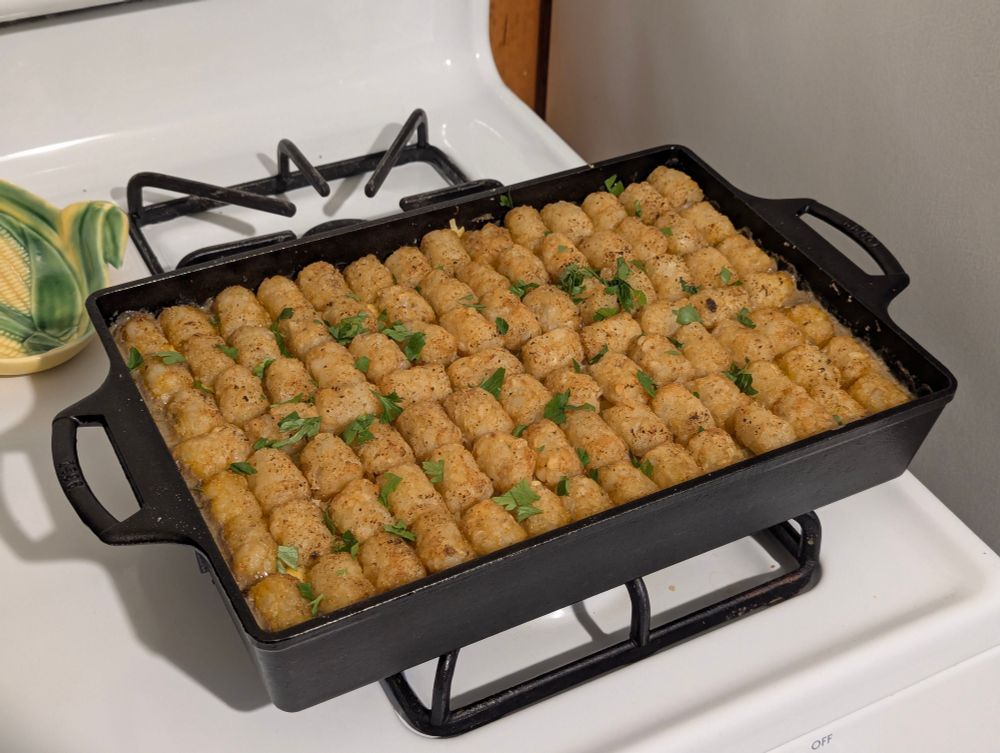 tater tot casserole in a pan on the stove after baking