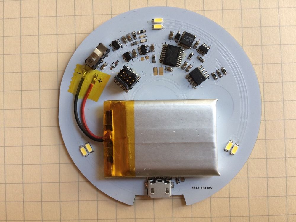Picture of a PCB, with a lithium-ion battery and components laid out in polar coordinates