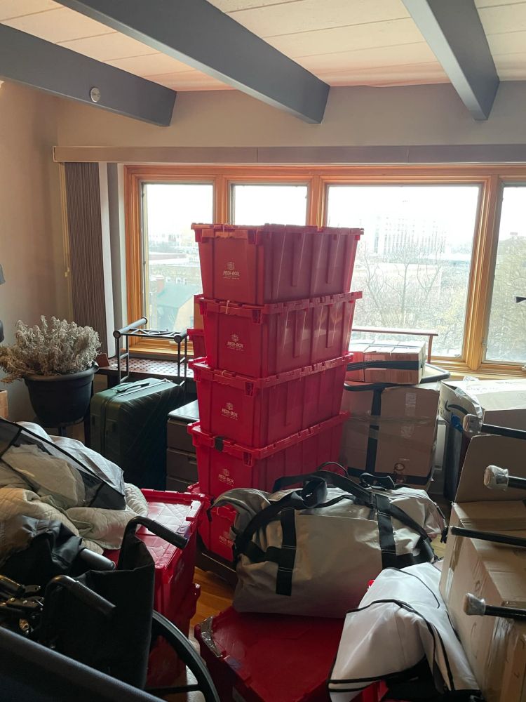 A stack of large sturdy red one piece crates that we rented from redibox for our recent move