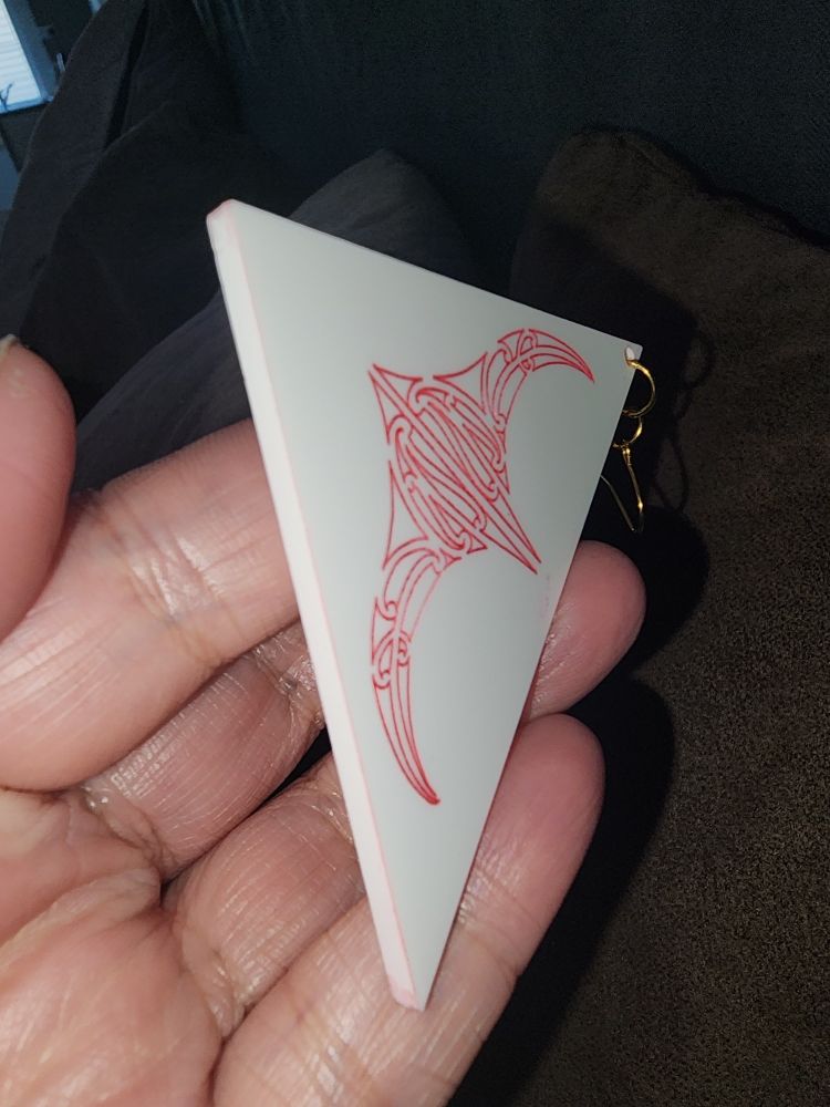 Triangular earring in white acrylic with engraved stingray stained in red paint