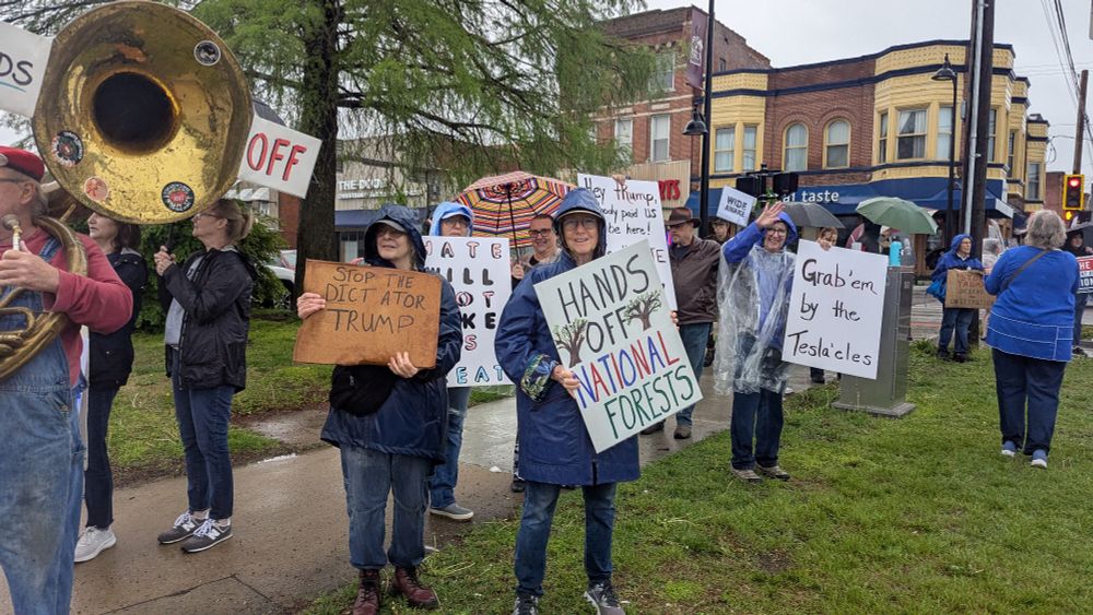 Several folks with signs protesting