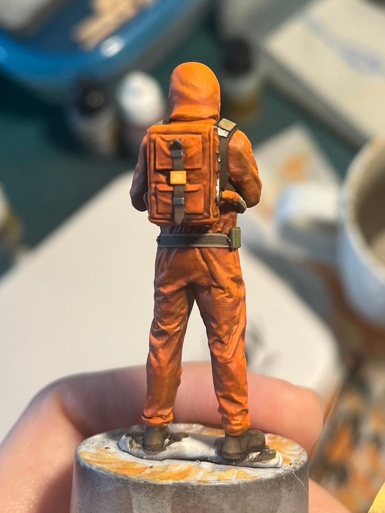 1/35 miniature of an Ecologist from the stalker games. From the back. He has a big backpack.