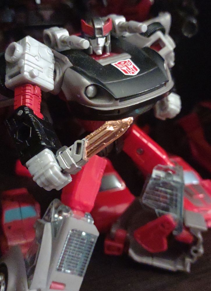 Bluestreak figure weilding copper coated Bowie knife.