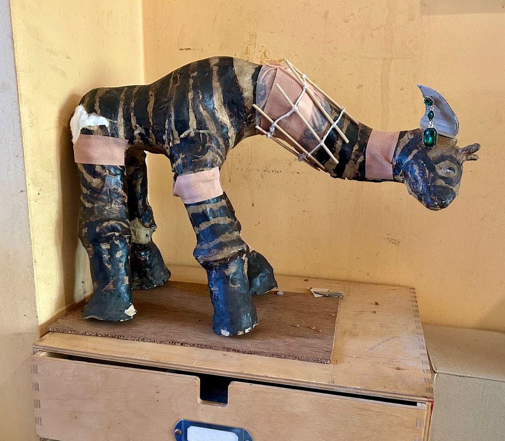 Pottery giraffe broken in many places, mended