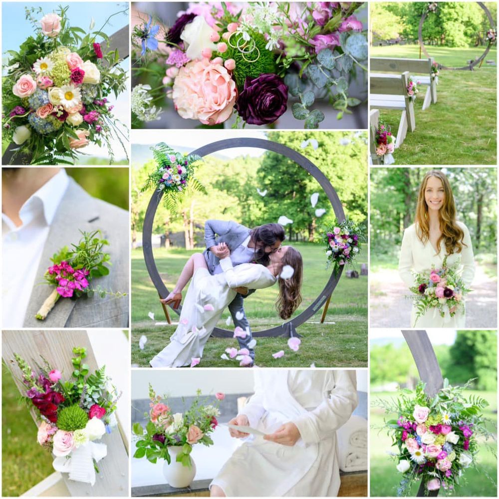 Collage of wedding floral arrangements.  In the center is a picture of a bride and groom kissing under a wooden arch decorated with flowers and with pink rose petals thrown in front of the camera. It is a sunny day outside with bright green trees in the background. Other collage photos show close ups of bridal bouquet, boutonnière, arch decorations, aisle bench markers, and wedding rings on top of bouquet.  Color scheme is pinks, purples, whites, and bright greens and is very spring themed 