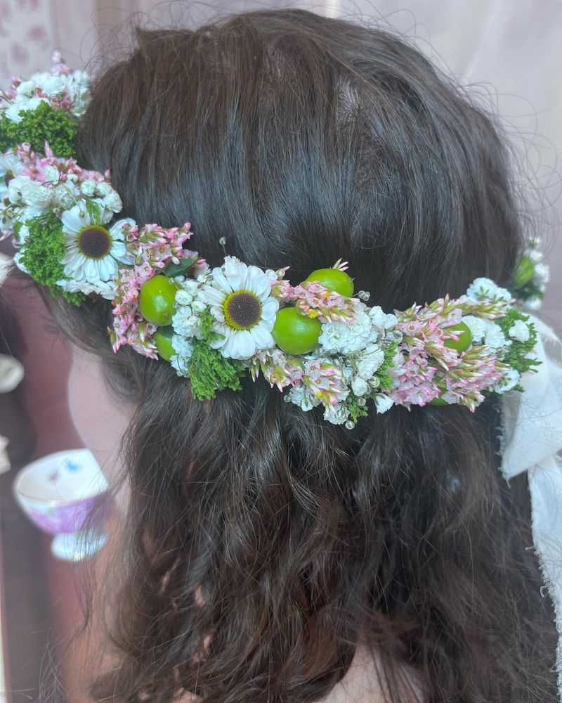 Same flower crown as described in the first picture, but closer up and showing the back of the crown and the back of the woman’s head.