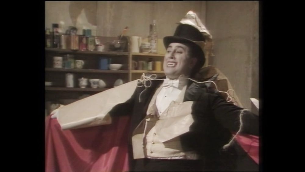 Alexei Sayle as a vampire in the ‘Nasty’ episode of The Young Ones (season 2 episode 3). He has just arrived to London in the mail from Transvaal (but claims to be a driving instructor from Johannesburg).