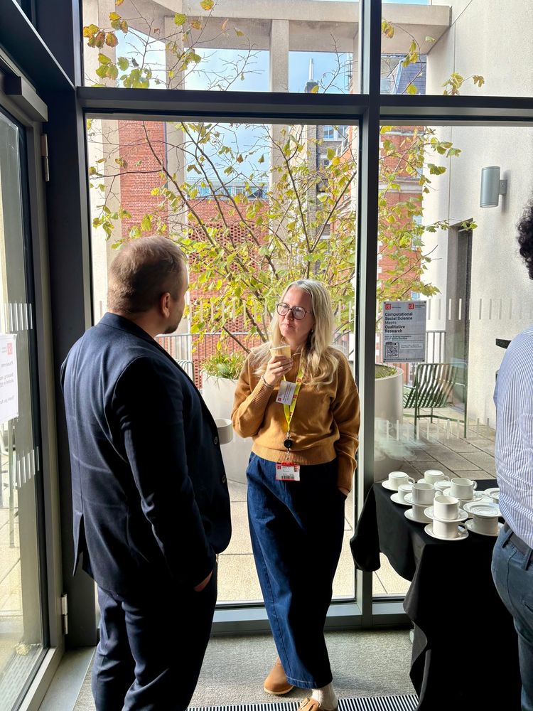 Two people stand and talk 