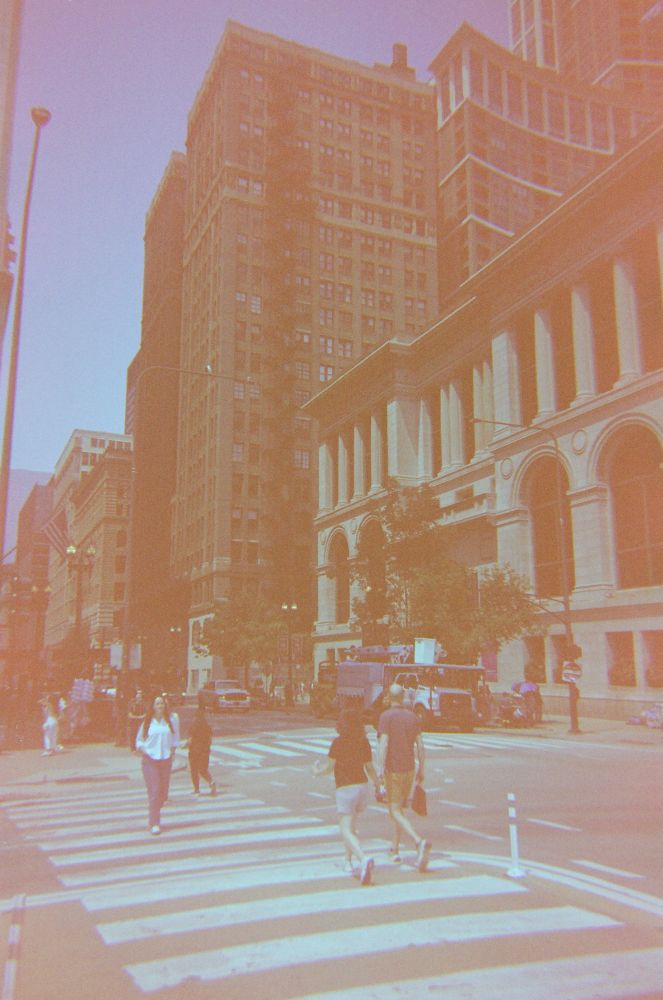 Green Blue tinted expired film; photo of Street photography in a city; people at crosswalk