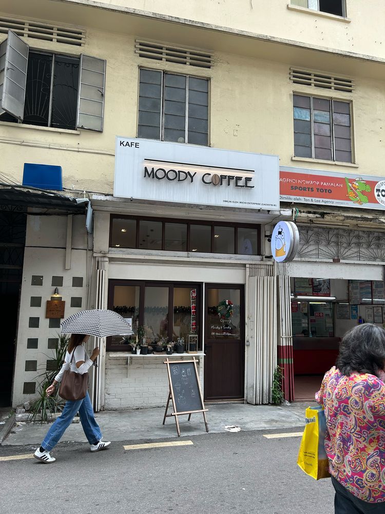 A cafe shop in the corner of a shop lot