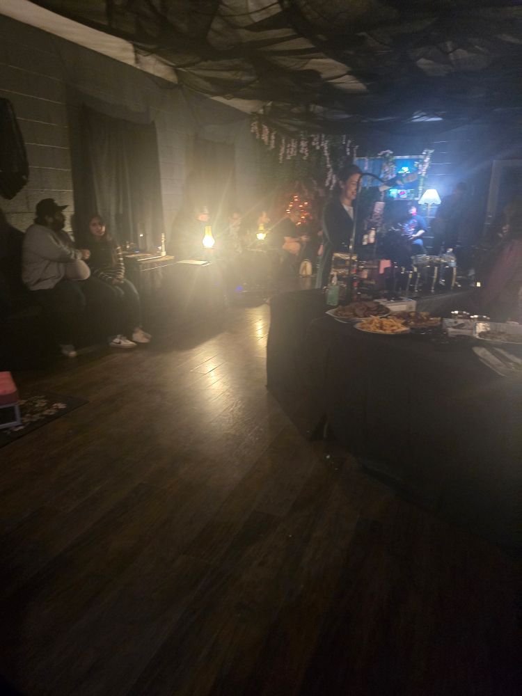 Lots of people hanging out in a goth space