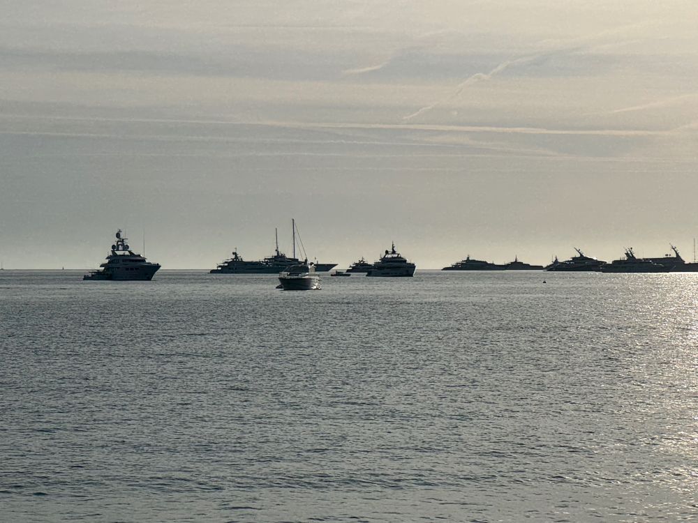 Horizon of the Bay of Saint Tropez littered with the silhouettes of giant yachts.