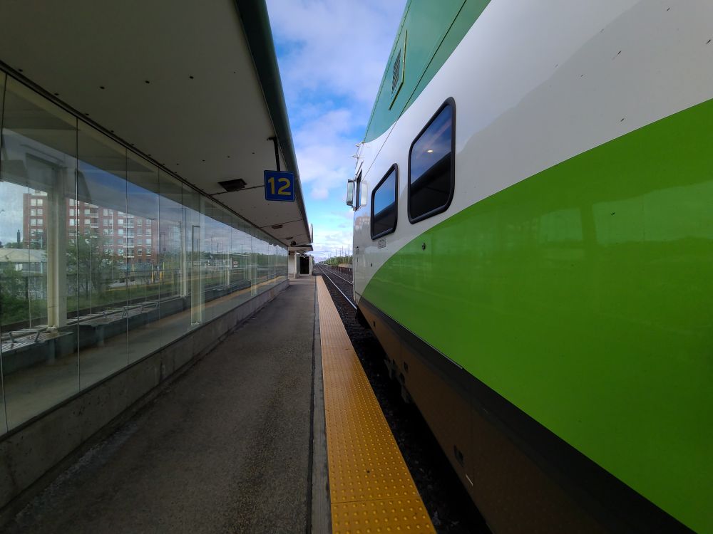 Photograph looking down a platform with a GO Transit cab car on the right