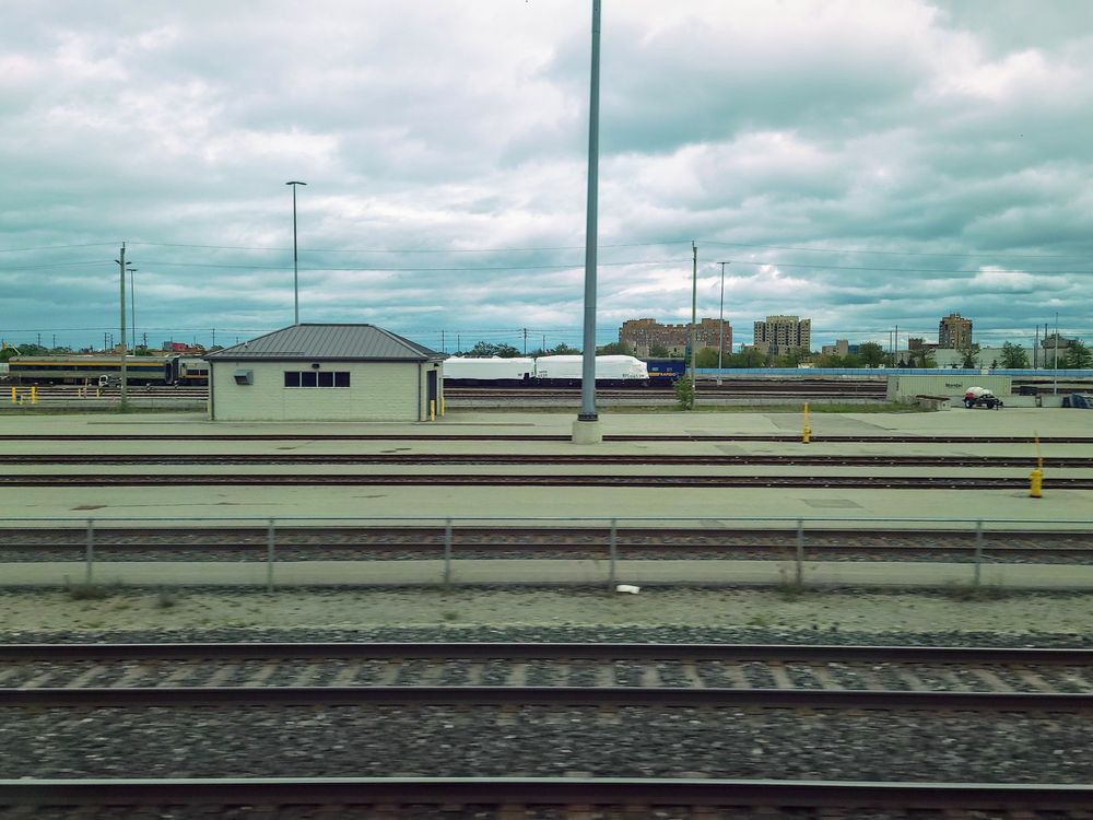 VIA 6539 locomotive sitting wrapped in a railyard 