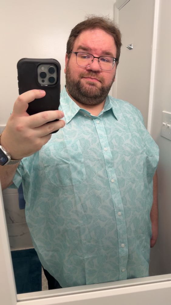 A light blue green shirt with a leaf print