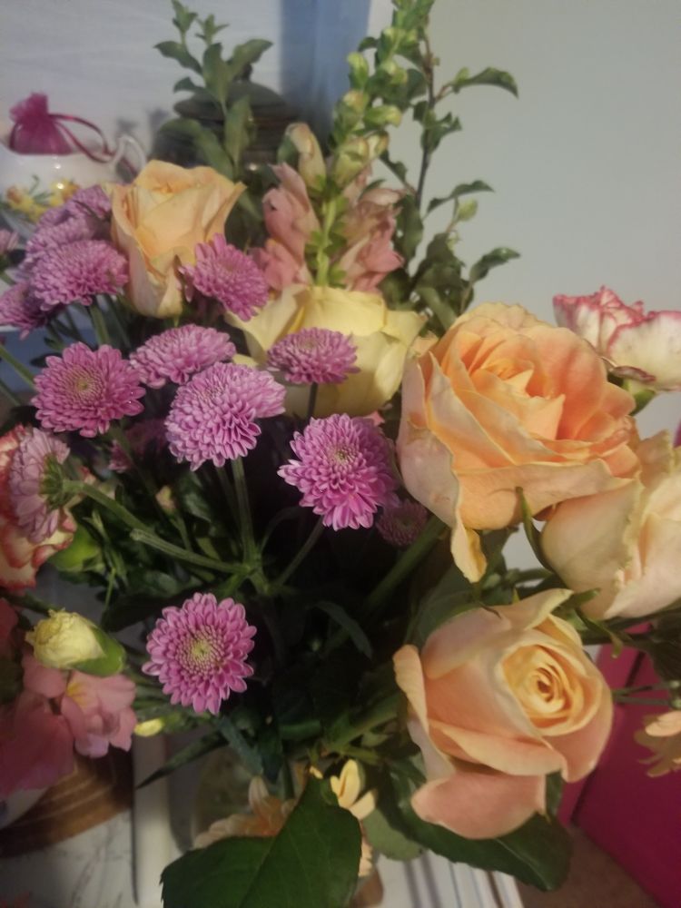 Flowers! Some green stuff. Silly pink things I love but do not know what they are. Purple pompom like blooms. Big happy orange ones. And creamy orange pink Rose's. Definitely giving that outfit stede is wearing when he runs his ship aground in s1.