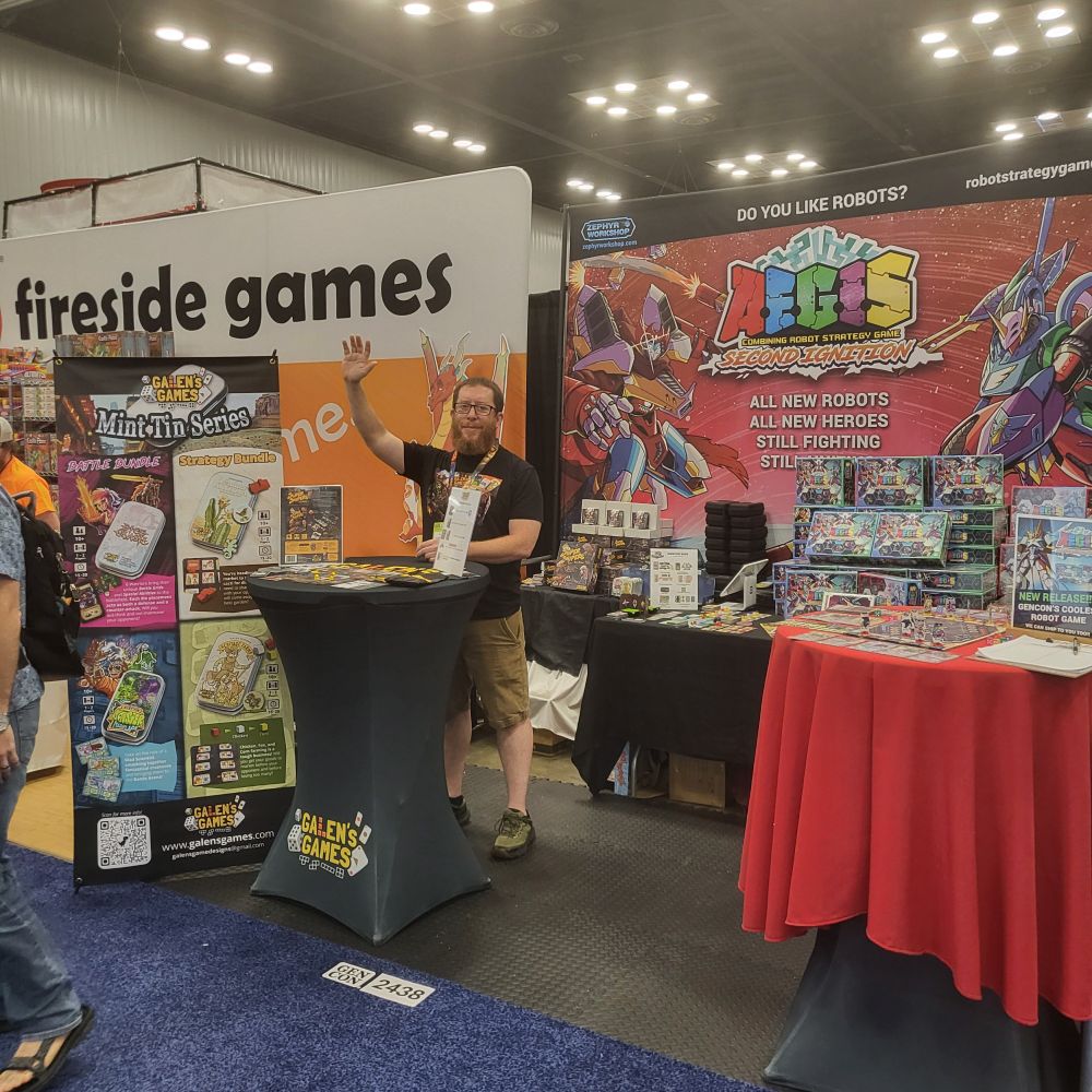 Photo of Galen waving at the gen con 2025 AEGIS COMBINING ROBOTS booth