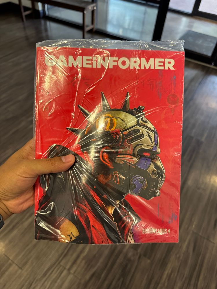 Me holding the July 2025 issue of Gameinformer magazine