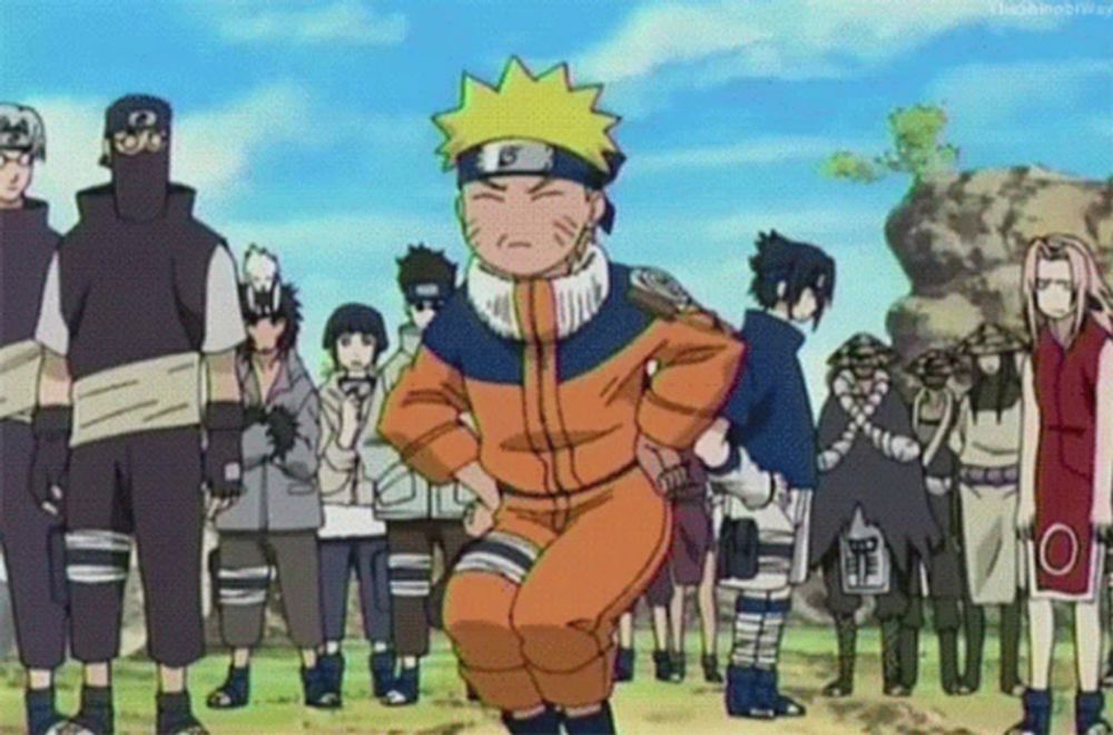 a group of people are standing around a cartoon character named naruto .