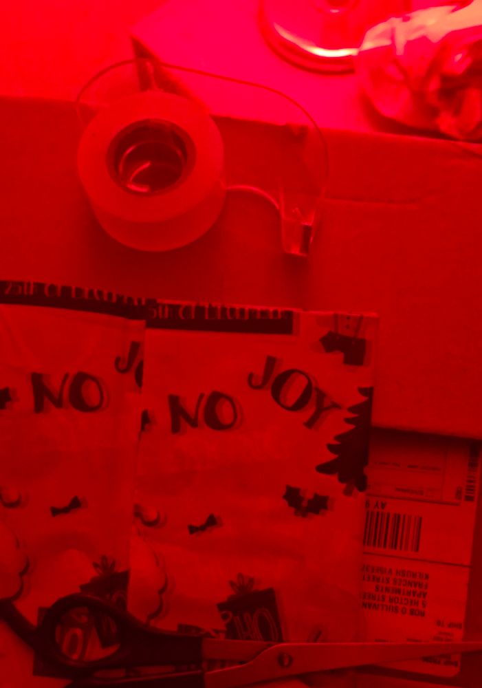 The same paper viewed under red light has washed out the word "peeking" so it now appears to read "No joy".
