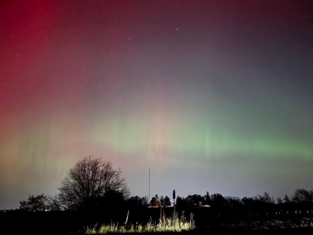 A banner of green is the luminous edge of the aurora as the crimson begins to fade.