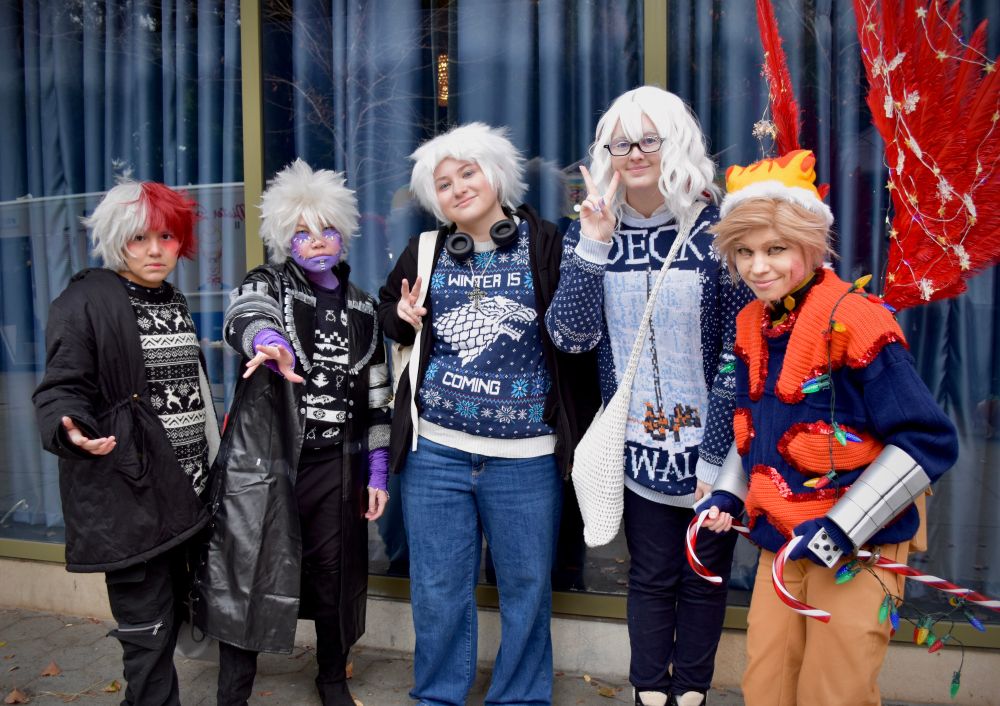 Posed photo of cosplayers dressed as Shouto, Dabi, Natsuo, Fuyumi, and Hawks all wearing Christmas sweaters.