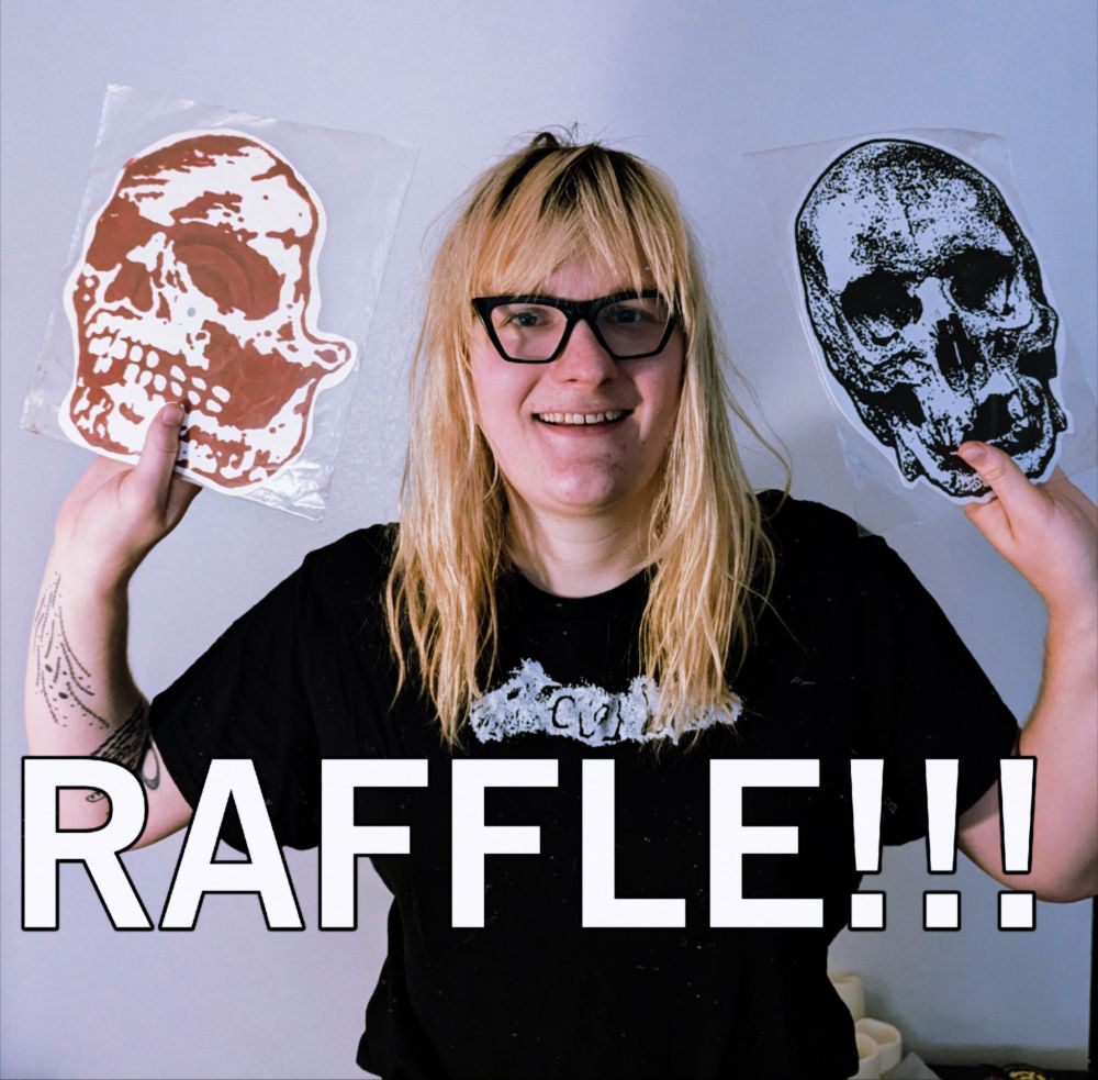 me Kim, holding the 2 skull records with the text RAFFLE!!!