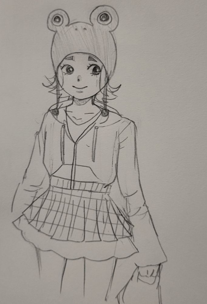 A drawing of a girl with short hair wearing an outfit that consists of a frog head hat, a v-neck t shirt, a zip-up hoodie, a plaid pleated skirt with a fluffy underskirt, and a small handbag. She is smiling and looking off to one side.