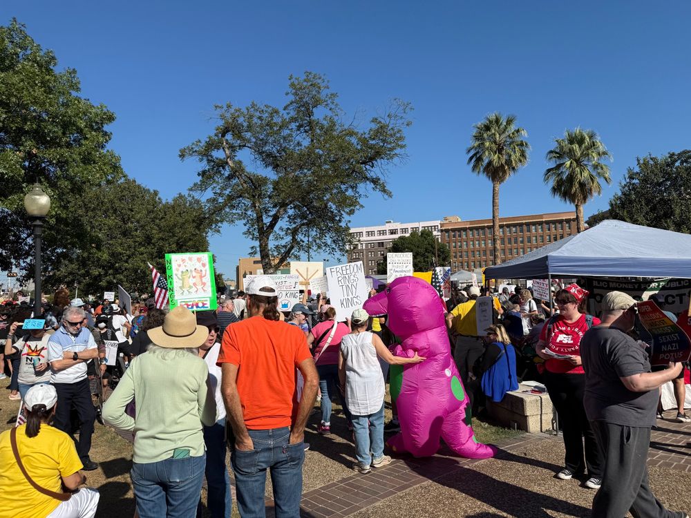 No Kings protest in San Antonio, Texas. Many are wearing costumes and hand-made signs against tyranny.