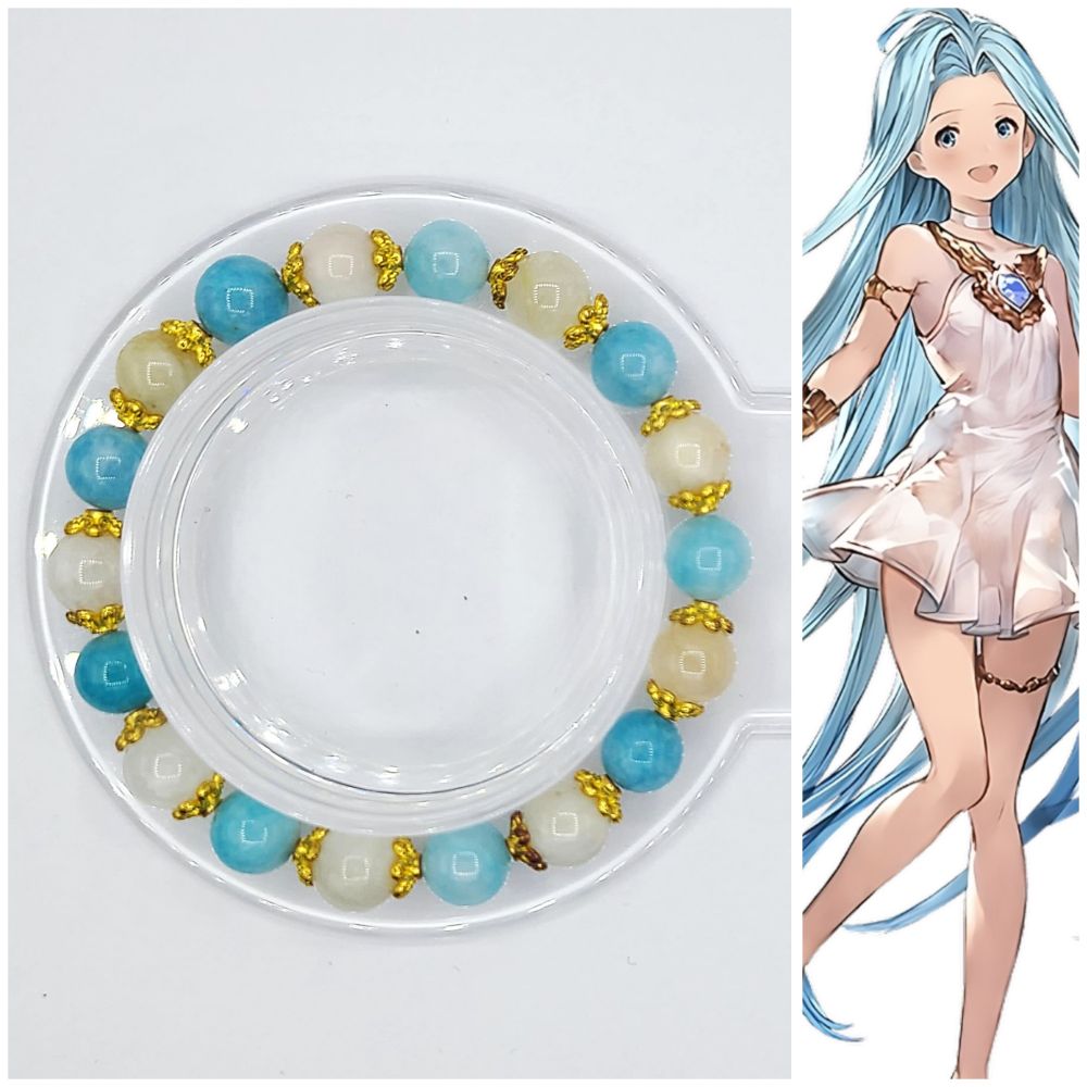 A bracelet crafted with 8mm gemstone beads. Gemstones used are White Moonstone and Chalcedony that is dyed to look akin to Larimar, and sports gold spacers. This bracelet is inspired by Lyria from Granblue Fantasy. 