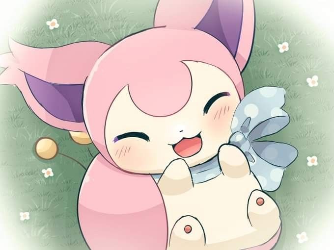 cute skitty laying in the grass she is so happy :)