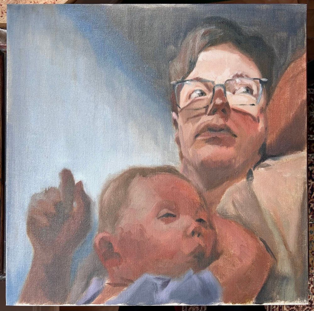 A bespectacled man, face illuminated by light, leans back on a chair while a baby rests on his chest, nearly asleep. The man looks off canvas to the right. Painted in warm, earthy reds and yellows against a grey, cool background