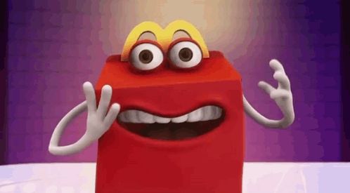 a happy meal box with big eyes and a mcdonald 's logo on top of it .