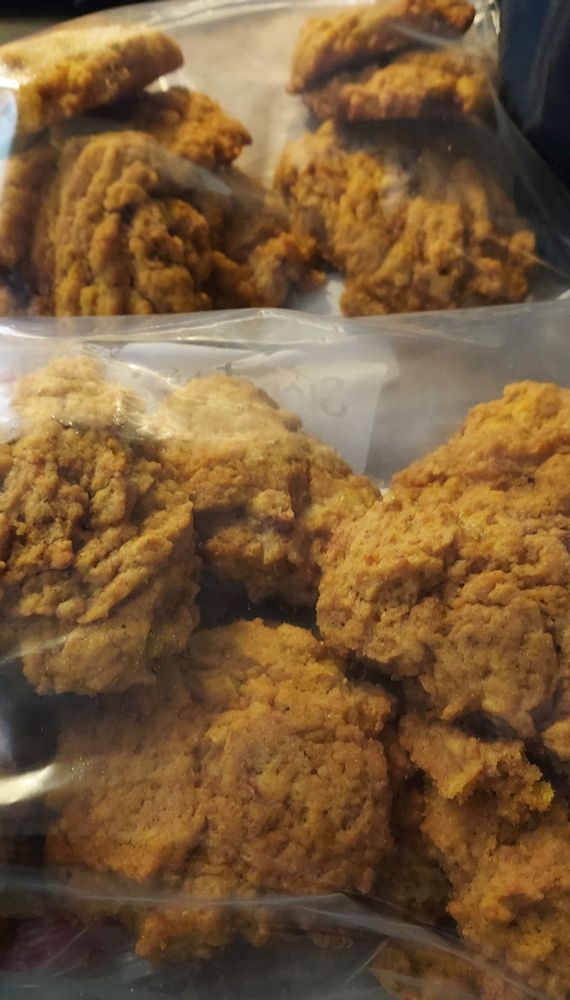A batch of pumpkin cookies that are stored inside plastic bags. 