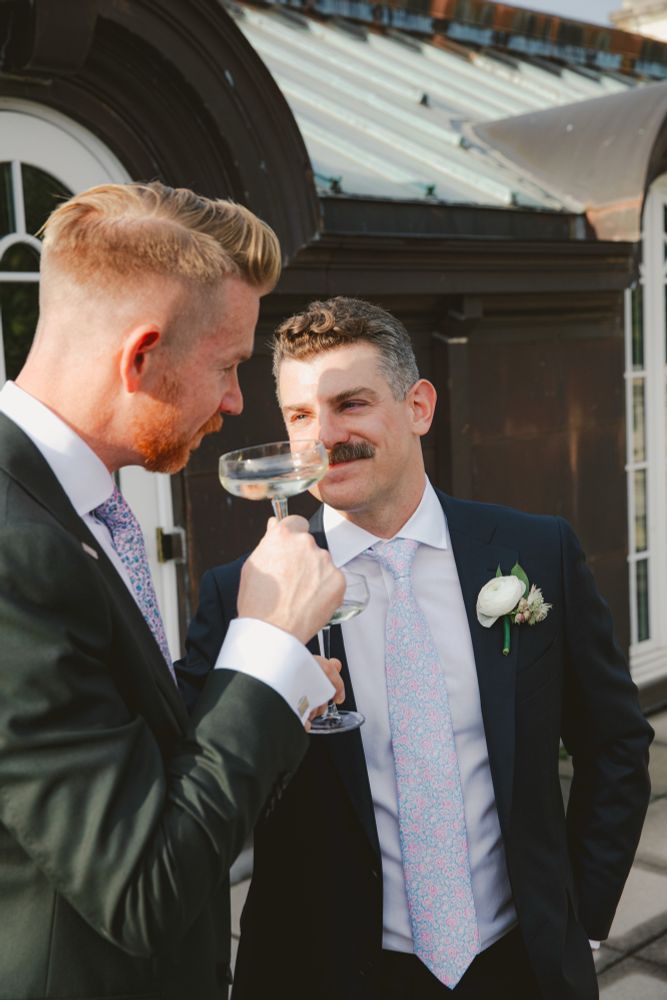 PT, in his wedding suit and with the light in his eyes, looking lovingly at G while sipping champagne. 