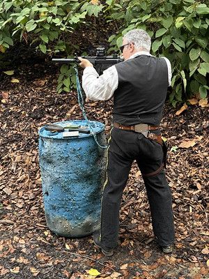 A photo of the author wearing 19th Century-style clothing firing a modern AR-15 platform.