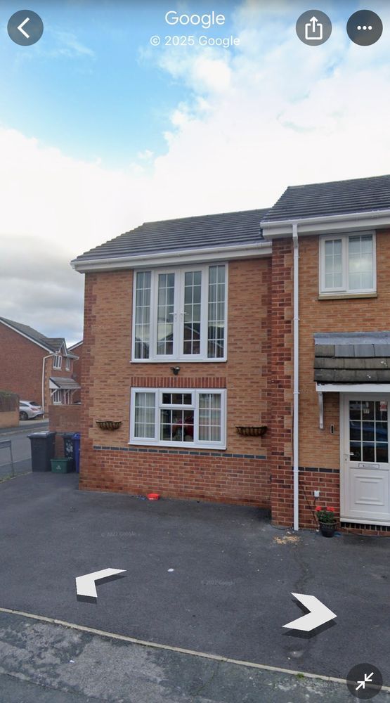 Screenshot of Google Streetview, showing an extension of a UK house with a set of patio doors on the first storey. There are no railings, or a balcony. Just patio doors into thin air. They even have handles on the outside.