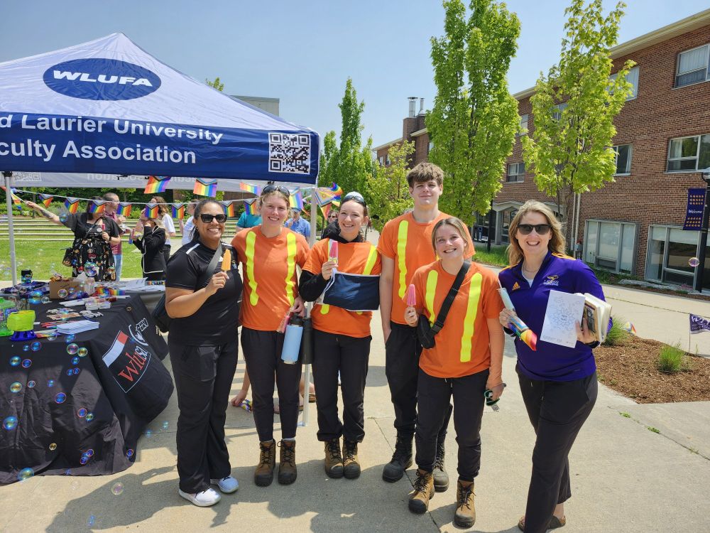 Photo of smiling workers at WLUFA/WLUSA Pride event.