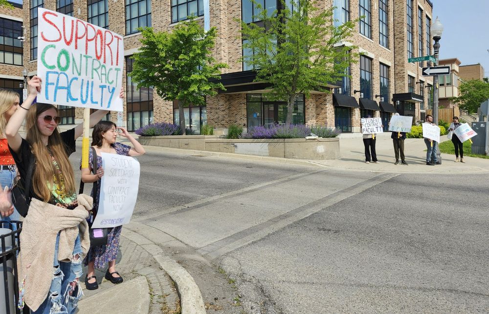 A photo of student supporters with signs about Contract Faculty Support