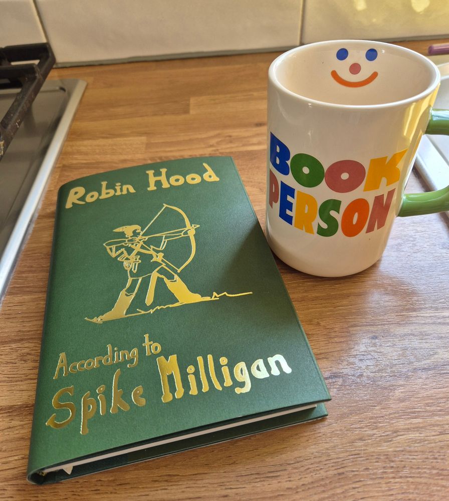 Mug with 'Book Person' on it alongside a limited edition copy of 'Robin Hood: According to Spike Milligan'