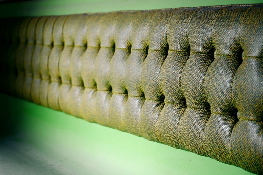 Photograph. Detail of green, 1970s fiberglass and textile restaurant seating.