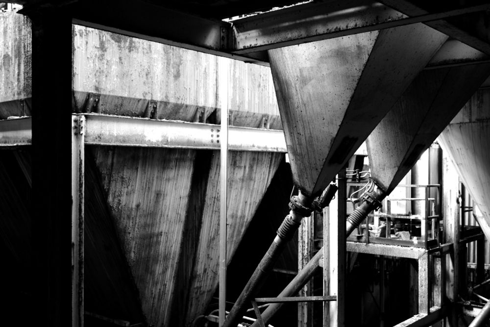 Black and white photograph. Large industrial equipment related to gelatin production in an abandoned factory.