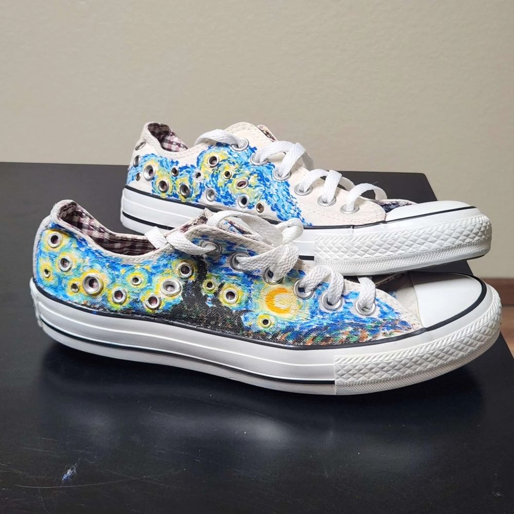 White Converse low top shoes with rivets and Starry Night painted on them.