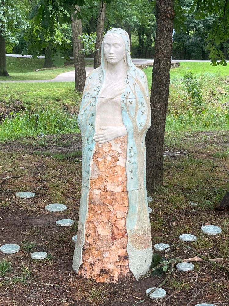 Art installation: statue of a woman among the trees at Antioch Park.