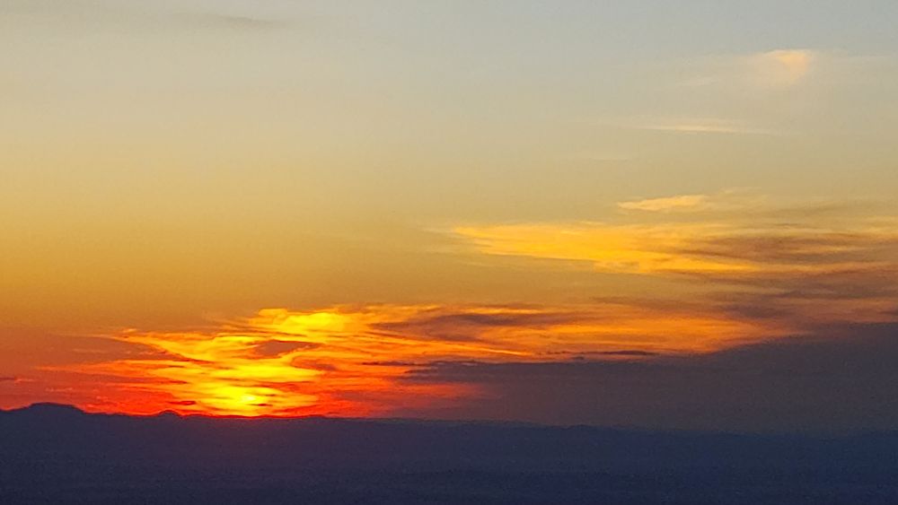 Sunlit clouds at days end from Mt.Archer near Rockhampton AU.