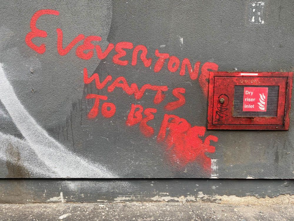 Everyone wants to be free. Red paint on concrete. Glasgow.
