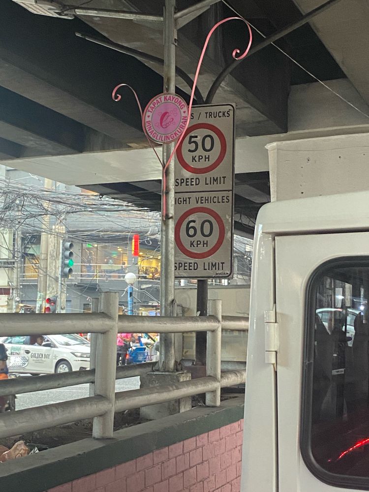 A speed limit on Taft is posted in the middle of the photo. It says the limit for trucks is 50 kph while light vehicles are 60 kph